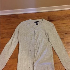A whiteish-grayish soft cardigan.